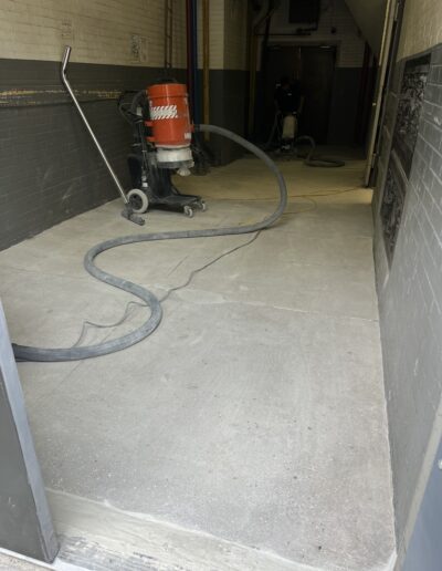 A wet floor cleaning machine in a garage