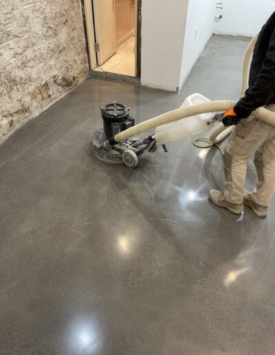 A man using a vacuum to clean a floor